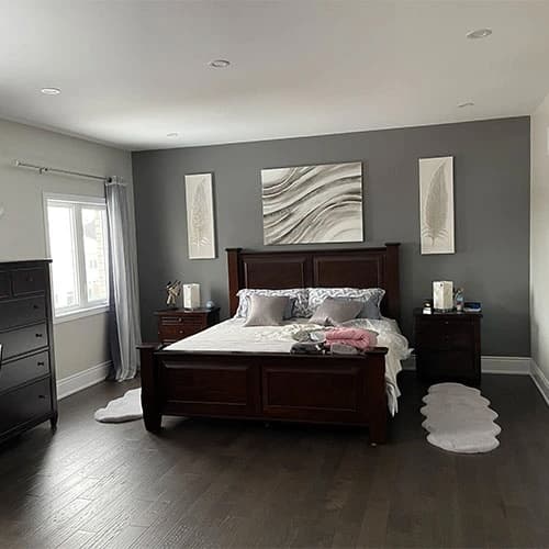 Painter rolling a fresh coat in a Toronto family room